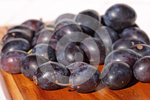 Damsons on wooden chopping board B