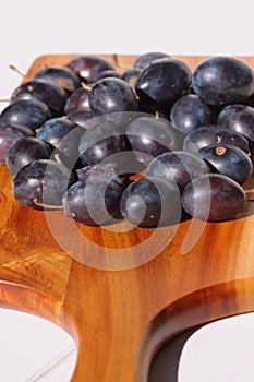 Damsons on wooden chopping board D