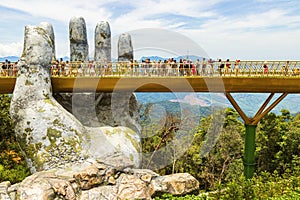 Danang, Vietnam - JUNE, 24, 2019: The Golden Bridge in the Bana Valley, supported by a giant hand This bridge is 1,400 meters photo