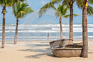 Danang Beach with coracles and a traveler