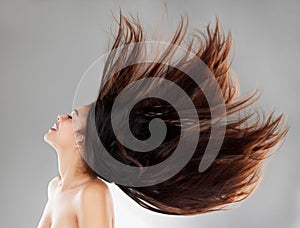 Dance as though EVERYONE is watching. Studio shot of a beautiful young woman with flowing hair against a grey background