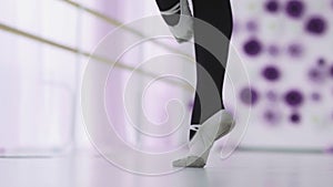 Dance of the ballerina. Female ballet dancer dancing in pointe shoes in studio.