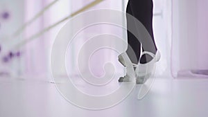 Dance of the ballerina. Female ballet dancer dancing in pointe shoes in studio.