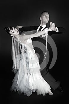 Dance ballroom couple in red dress dance pose isolated on black background. sensual professional dancers dancing walz, tango, slow