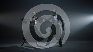 Dance couple bowing after performance. Ballroom dancers standing on stage.