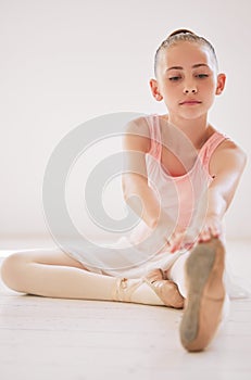 Dance girl exercise and fitness with a ballet dancer stretching before a training and workout routine in a gym or studio