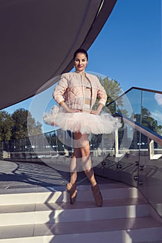 Dance Ideas. One Winsome Sexy Slim Professional Caucasian Ballet Dancer in Pink Tutu Dress Posing in Standing Pose With Straight