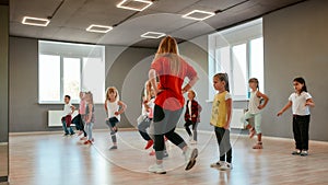 Dance for kids. Group of little boys and girls dancing while having choreography class in the dance studio. Dance