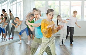 Dance lesson for children - girls and boys learn modern dances in pairs