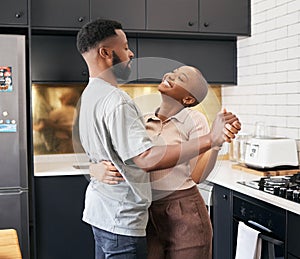 Dance, love and happy black couple in the kitchen having fun together in their new modern home. Happiness, smile and