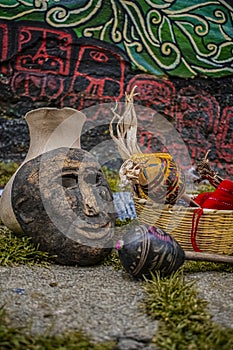 Dance mask, with adobe jar on the back and basket with chinchines around, photo