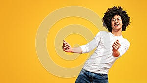 Awesome bushy guy dancing club moves on orange background photo