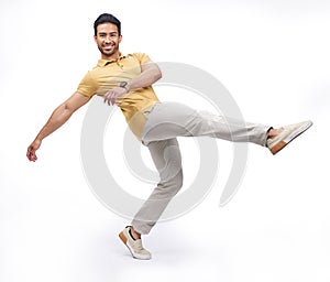 Dance, movement and portrait of man in studio for happiness, energy and performance with smile. Creative, happy and male