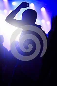 Dance, neon and silhouette of woman at music festival with crowd dancing at concert, lights and energy at live event