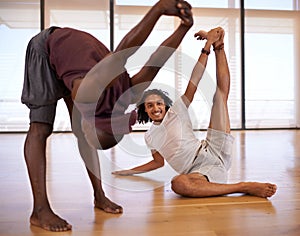 Dance is the quickest route to happiness. two male dancers stretching in the dance studio.