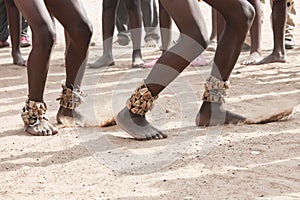 Dance on the sand. Feet of dancing Africans on the sandy surface photo