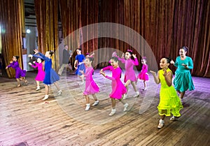 Dance school. Pupils take exams. Boys and girls in beautiful dance costumes on stage