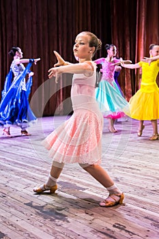 Dance school. Pupils take exams. Boys and girls in beautiful dance costumes on stage