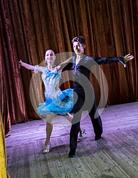 Dance school. Pupils take exams. Boys and girls in beautiful dance costumes on stage