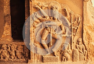 Dance of Shiva Lord with many hands. Entrance to the Hindu temple with 6th century reliefs. Ancient Indian architecture