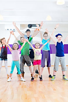 Dance teacher giving kids Zumba fitness class