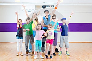 Dance teacher giving kids Zumba fitness class