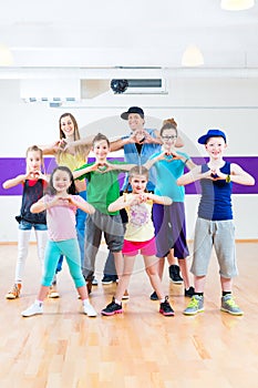 Dance teacher giving kids Zumba fitness class