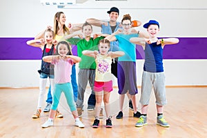 Dance teacher giving kids Zumba fitness class