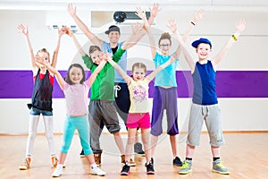 Dance teacher giving kids Zumba fitness class photo