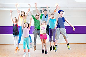 Dance teacher giving kids Zumba fitness class