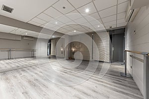 dance workout room with a mirror covered wall and wooden hallways photo