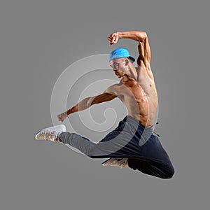 Dancer in a blue cap jumps