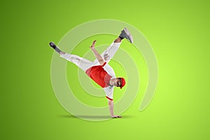 Dancer doing handstand isolated over green background