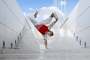 Dancer doing handstand on stairs