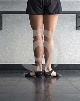 Dancer in First position at the barre in Jazz class