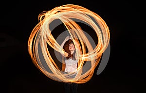 Dancer with flaming fire pois after dark.