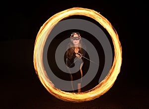 Dancer with flaming fire pois after dark.