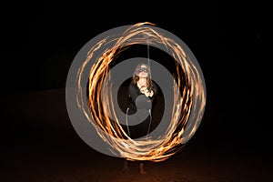 Dancer with flaming fire pois after dark.