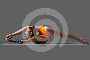 Dancer girl doing backbend acrobatic exercise