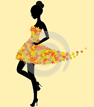 Dancer girl in dress of autumn leaves