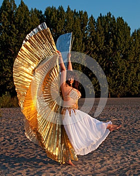 Dancer with Isis Wings on sand