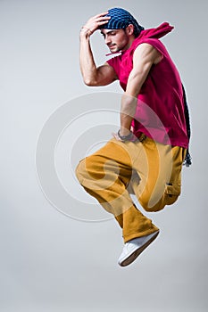 Dancer jumping over gray background