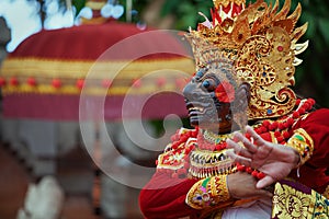 Dancer man in traditional Balinese costume and Topeng Wayang mask