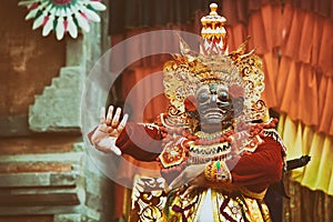 Dancer man in traditional Balinese costume and Topeng Wayang mask