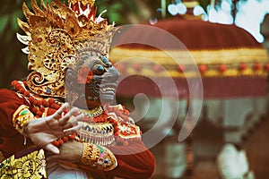 Dancer man in traditional Balinese costume and Topeng Wayang mask