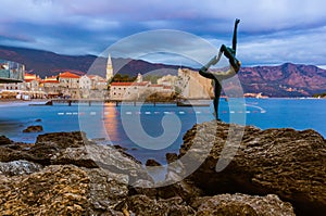 Dancer statue and Old Town in Budva Montenegro