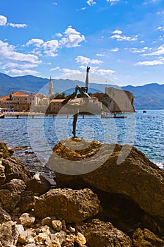 Dancer statue and Old Town in Budva Montenegro