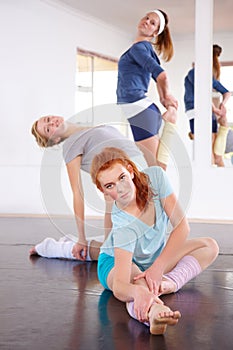 Dancer, studio and class stretching in exercise, practice for women and warm up for ballet. Fitness, training and group