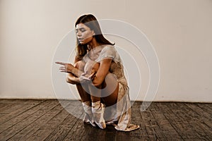 Dancer in studio, girl jumping and dancing  professional in light active wear