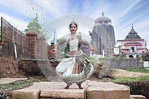 Dancer wears traditional costume and performs Odissi dance at Lingaraj Temple, Bhubaneswar, Odisha, India